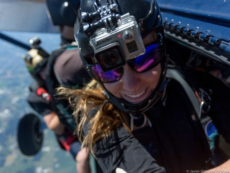 A person wearing a helmet and sunglasses with a camera on her head
