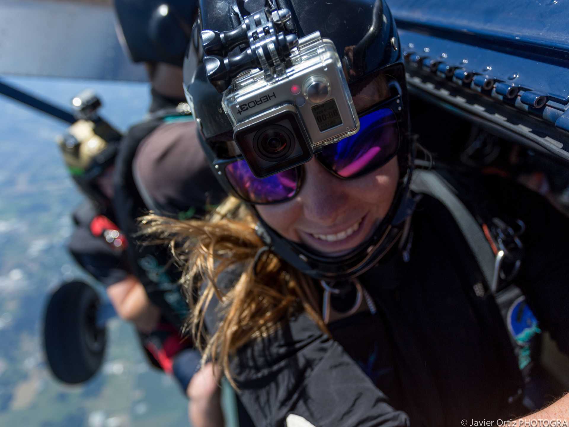 A person wearing a helmet and sunglasses with a camera on her head